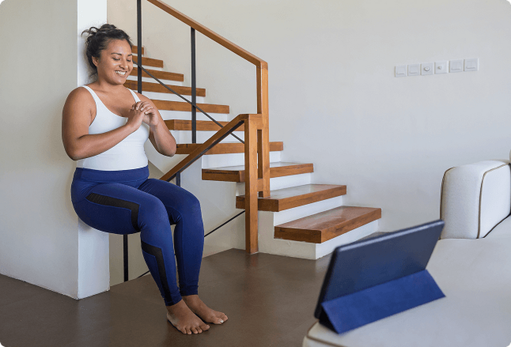 Woman doing wall sits